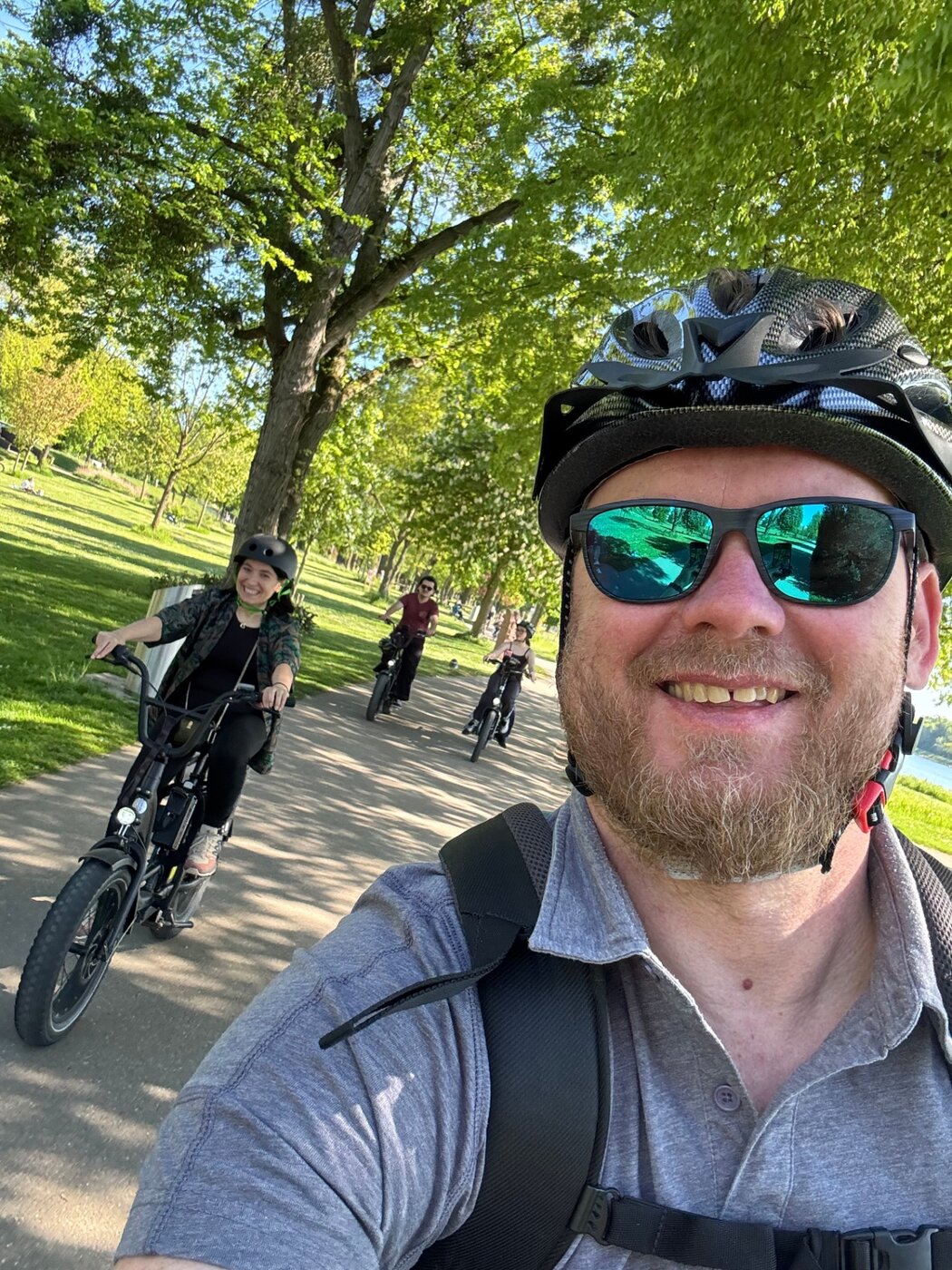STRIM Team riding e-bikes through a leafy park in Strasbourg